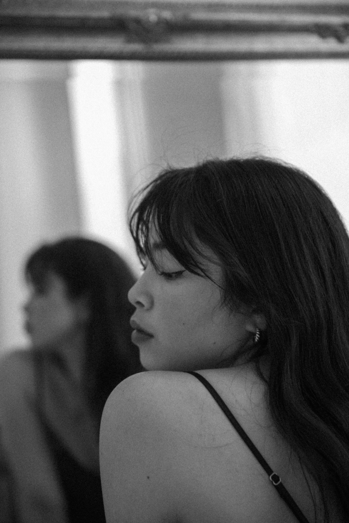 Black and white portrait of a woman looking over her shoulder