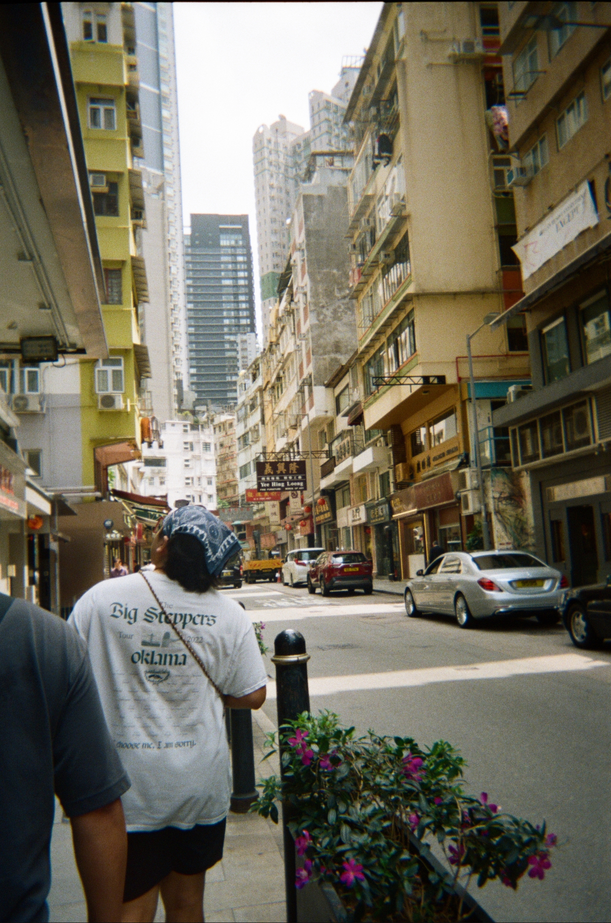 Looking down a Hong Kong street between old apartment blocks